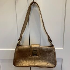 Gold handbag from The Sak